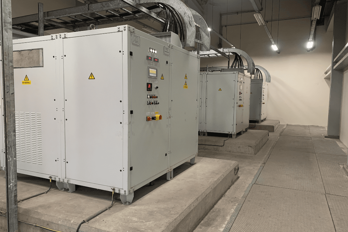 Industrial electrical panels in a facility room.
